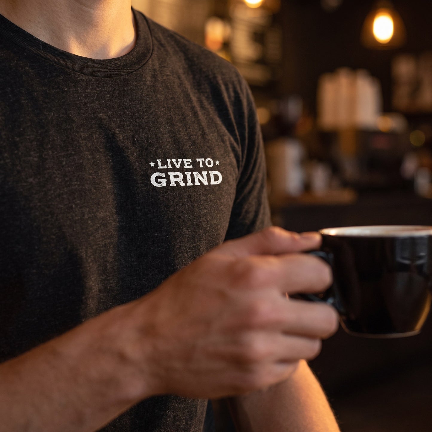 Close-up of the Live to Grind left chest print on the black heather Nashville Grind Logo Tee